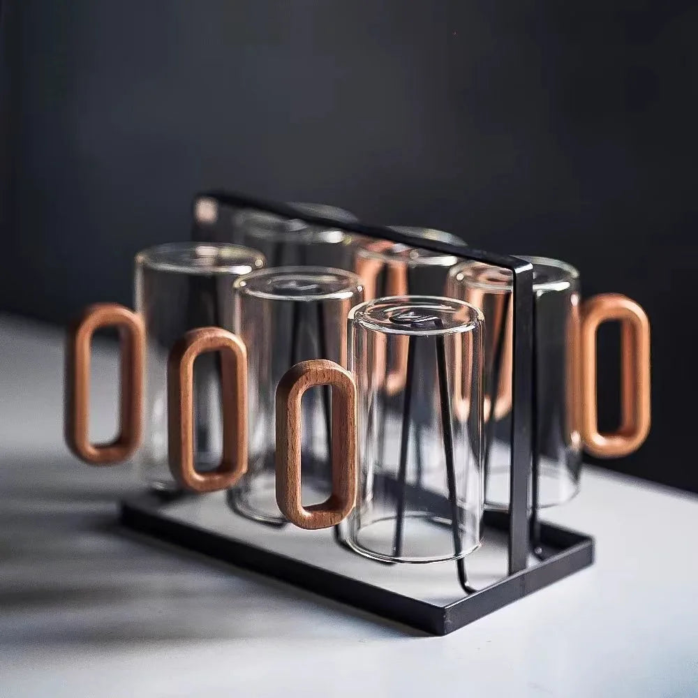 Six clear glass mugs with wooden handles in black metal rack