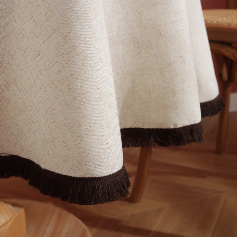 Cream linen blend tablecloth with dark brown tassel fringe detail