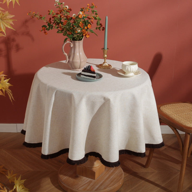Cream linen tablecloth with fringe trim styled for dessert service