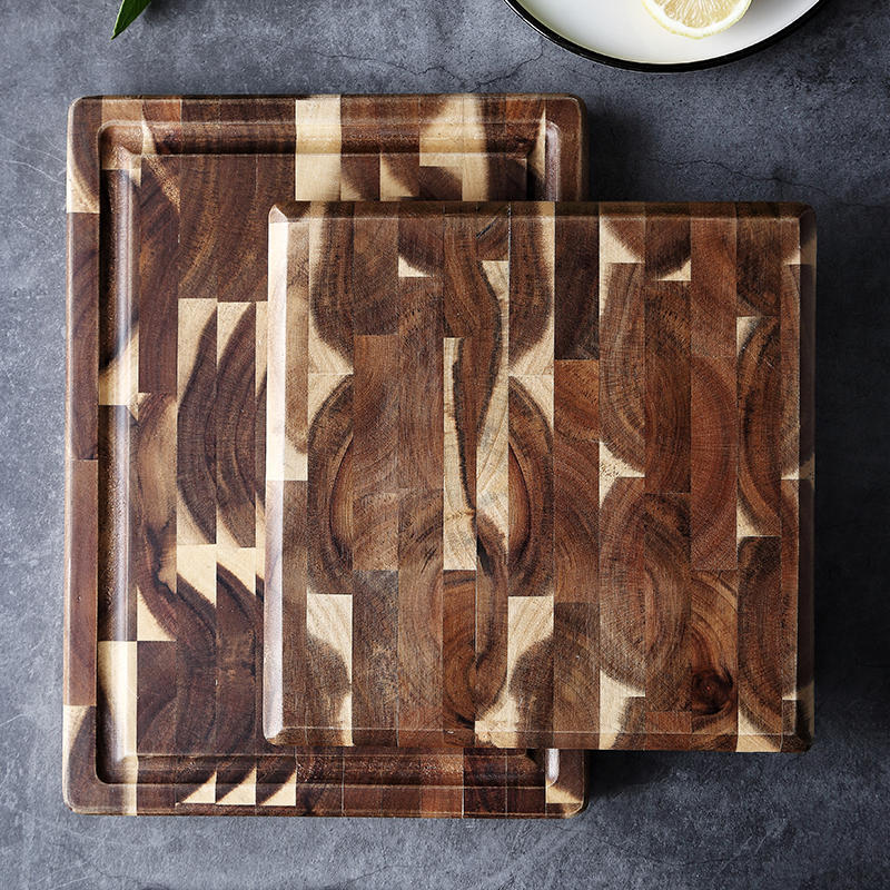 Stacked end grain butcher block cutting boards showing patchwork wood grain