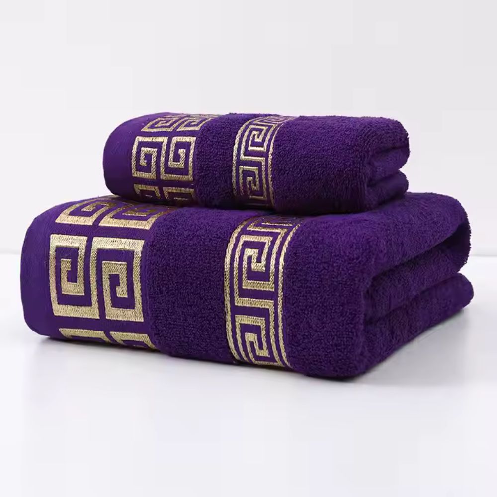 Purple bath towel set with gold meander fret embroidery and plush texture