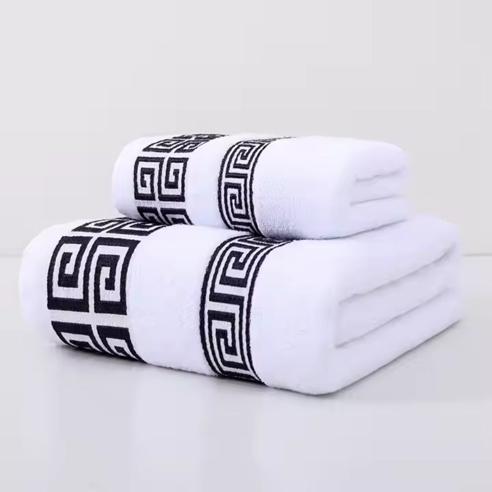 White bath towel set with bold black Greek key embroidery and soft terry texture