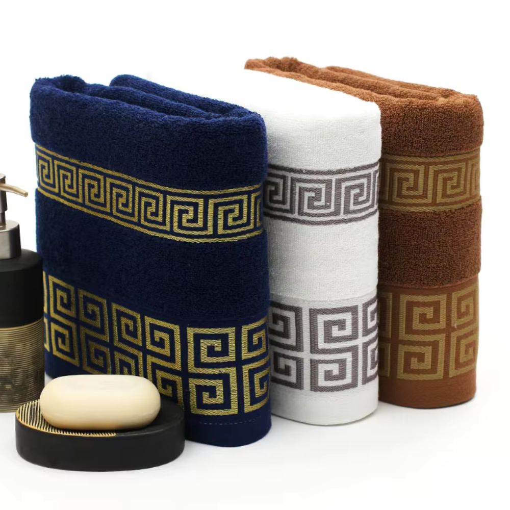 Navy white and brown bath towels with contrasting Greek key borders