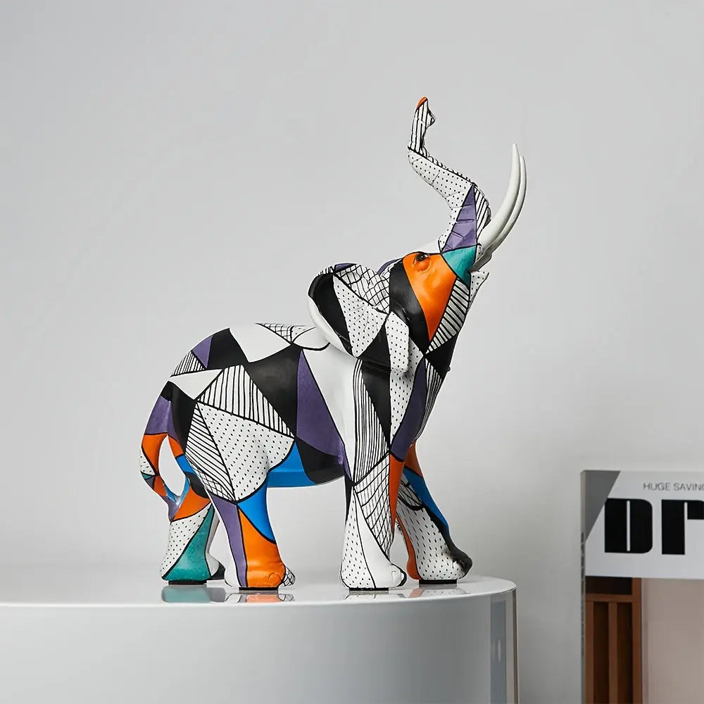 Modern resin elephant statue with vibrant geometric shapes and raised trunk