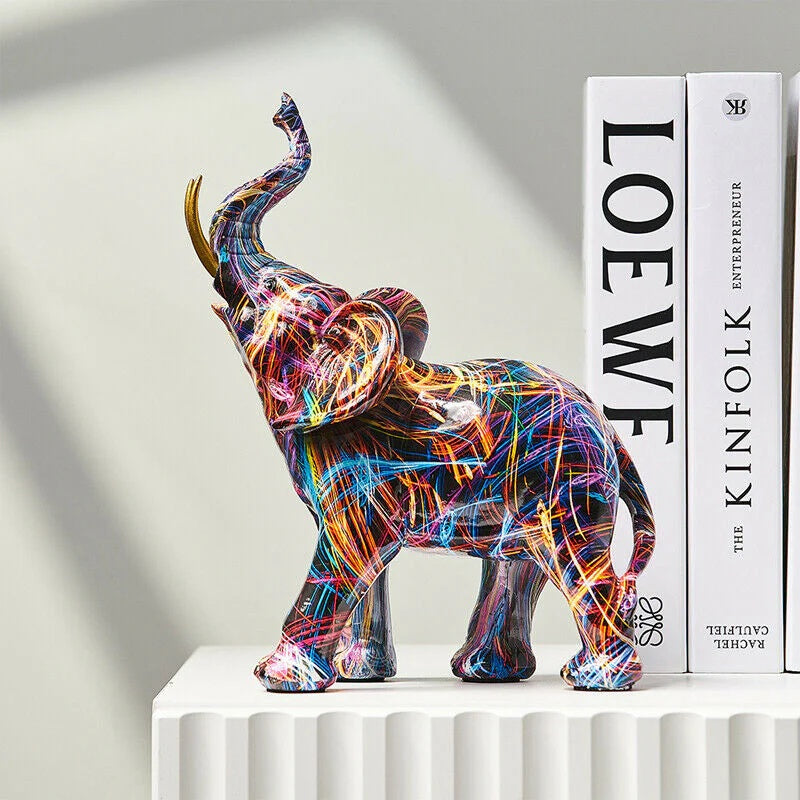 Gold tusked abstract elephant statue on white pedestal