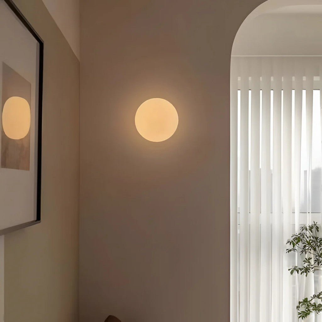 Concealed base spherical wall light creating soft glow in minimalist decor