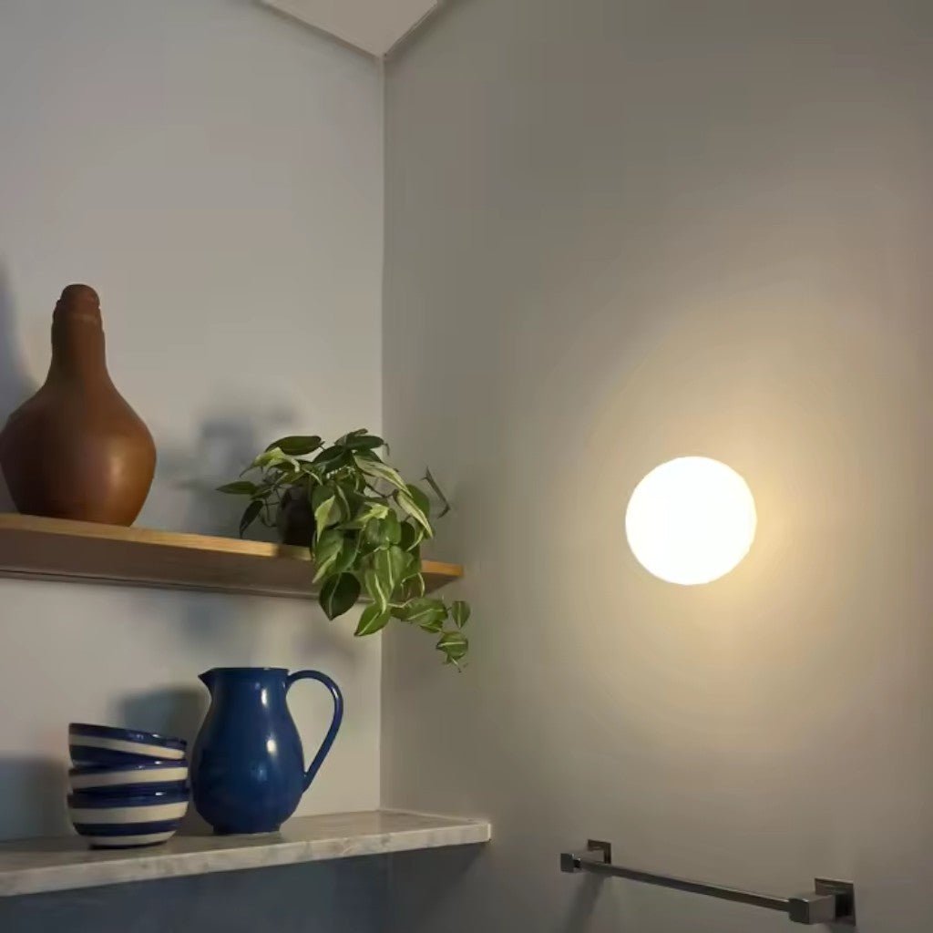 Japandi style floating glass ball lamp illuminating functional shelf space