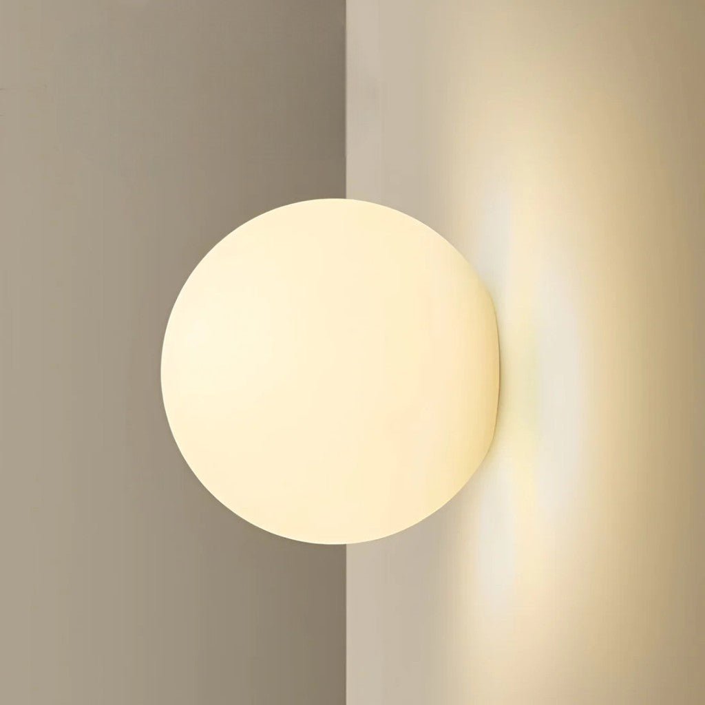 Floating sphere wall lamp mounted in corner with no visible backplate