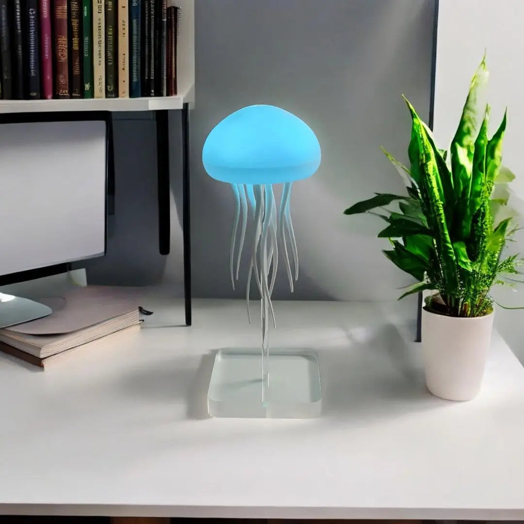 Blue glowing jellyfish table lamp with translucent shade and acrylic stand on desk