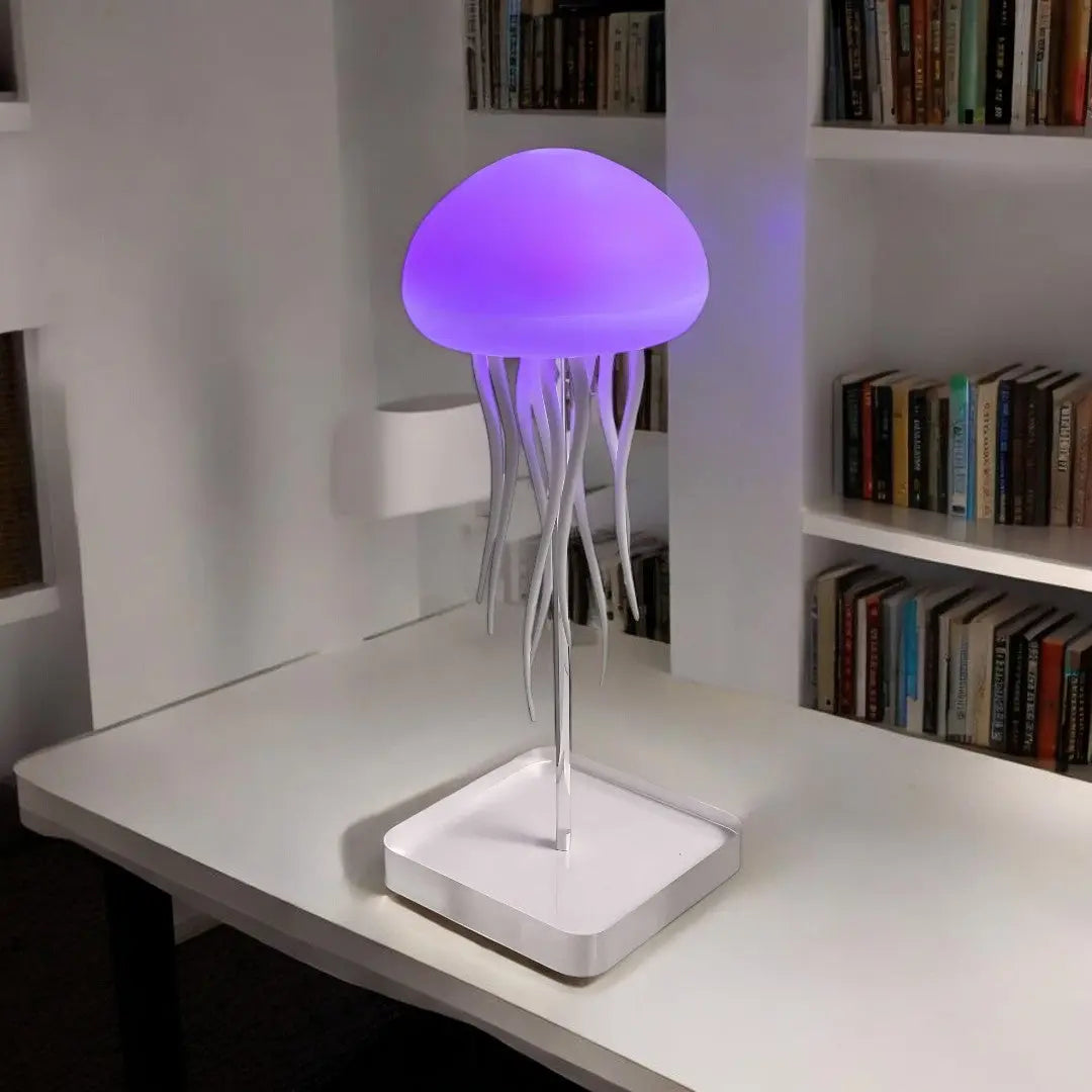 Purple glowing jellyfish lamp with soft ambient light on white desk surface