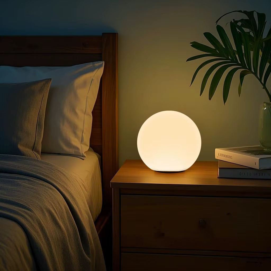 cordless rechargeable moon globe lamp warm white on bedroom nightstand