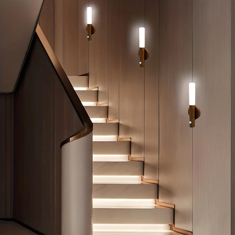 Set of three vertical motion sensor lights illuminating modern staircase steps