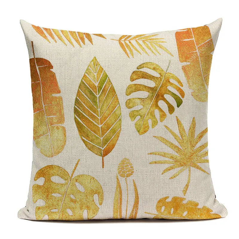Tropical gold and olive leaf print square pillow case on textured beige fabric