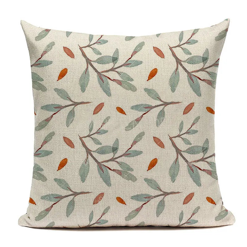 Sage green botanical branch cushion cover with autumn accent leaves