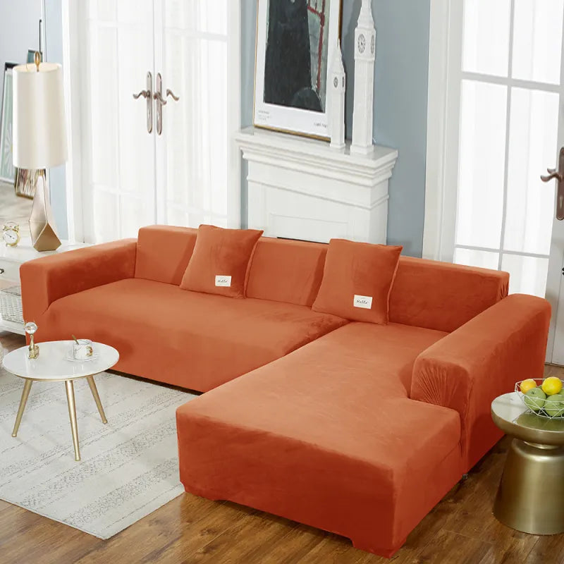 Orange stretch velvet sofa cover on sectional showing smooth fabric finish