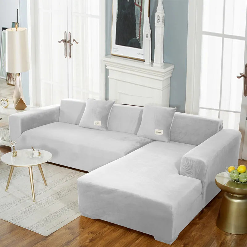 Light gray stretch velvet sofa cover on sectional with smooth fit