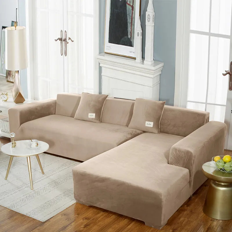 Beige stretch velvet sofa cover on sectional with 'hello' labeled pillows