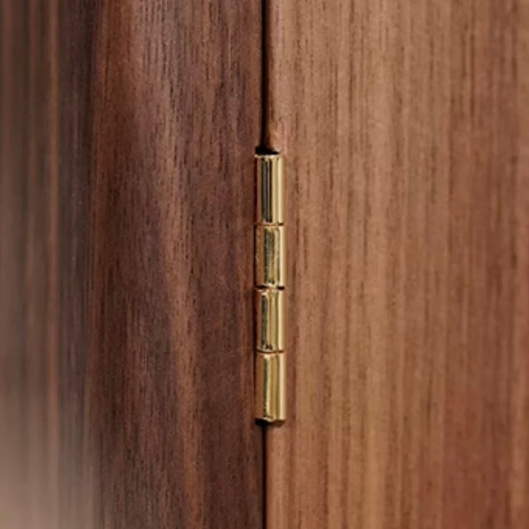 Polished brass hinge detail on solid walnut jewelry armoire