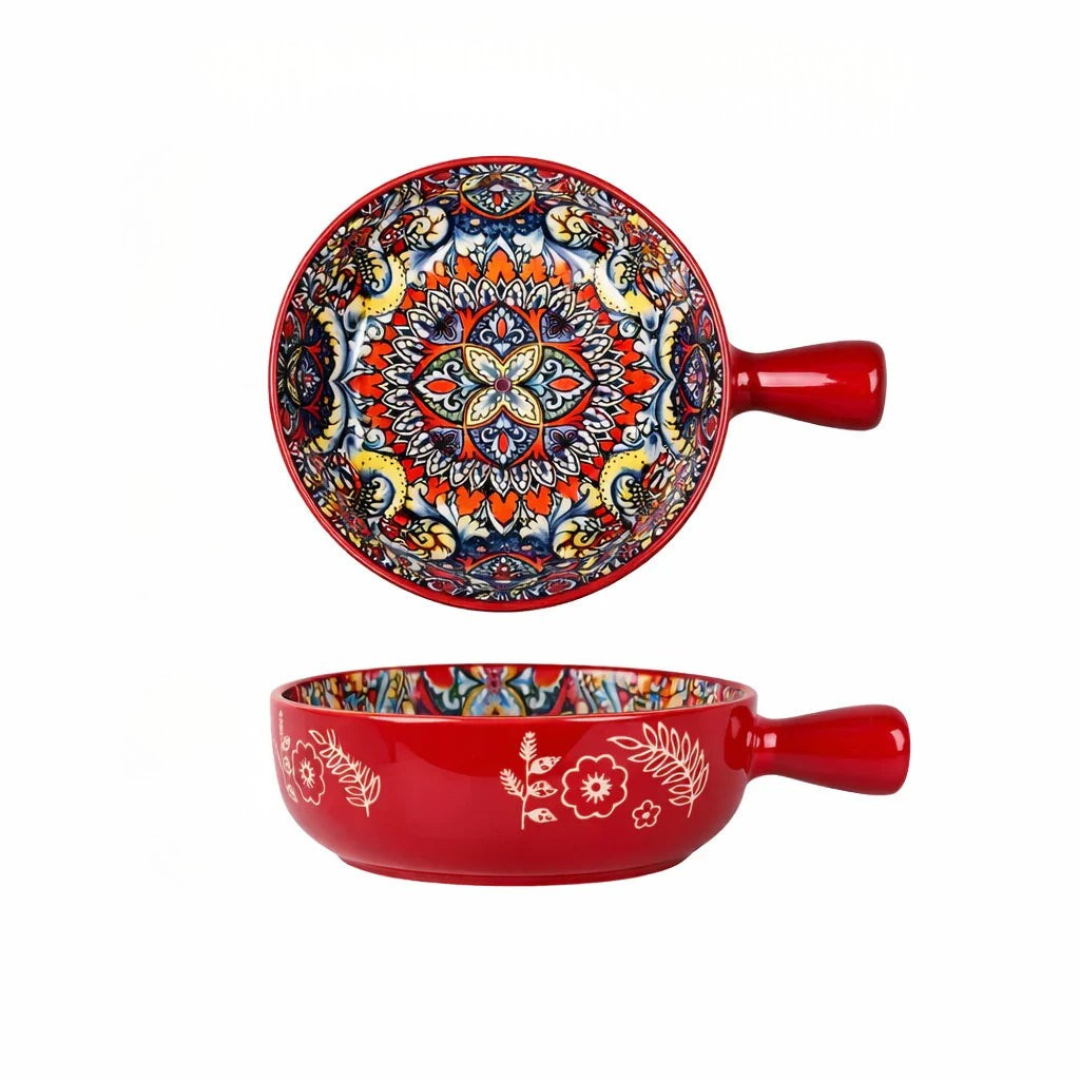 Red bohemian ceramic bowl with handle featuring multicolored mandala interior and white botanical exterior
