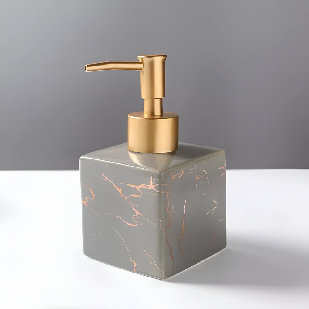 Matte grey ceramic soap dispenser with copper marble veining and gold pump