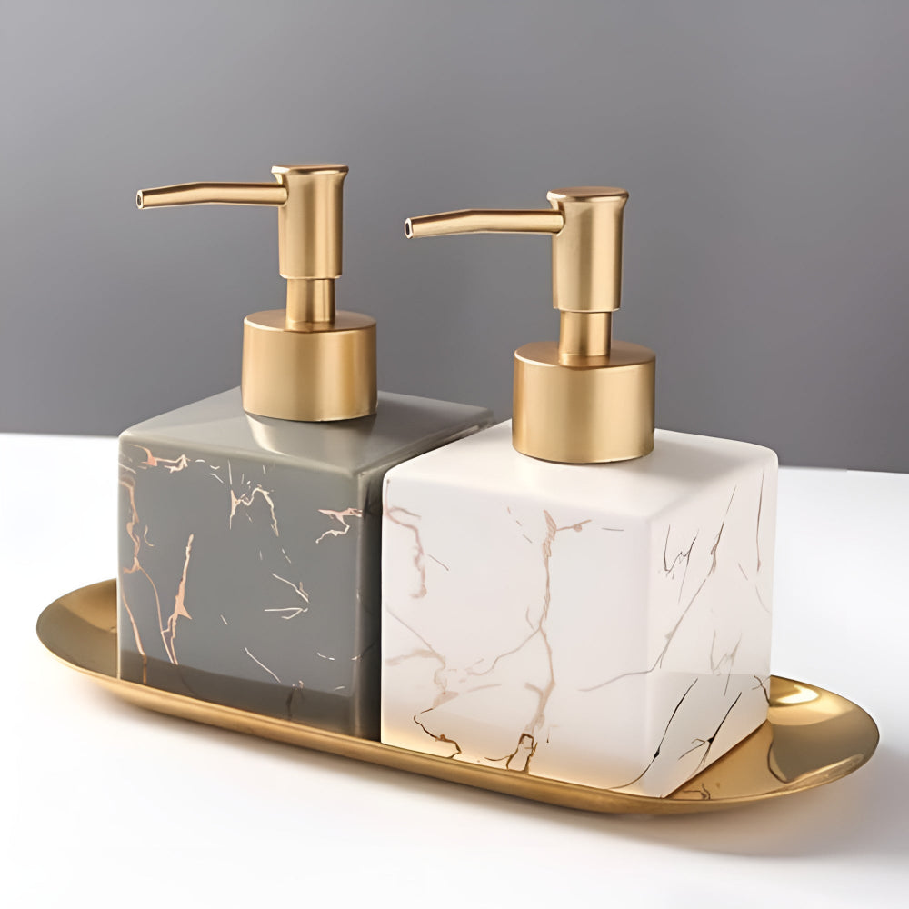 Grey and white marble ceramic soap dispensers on gold tray