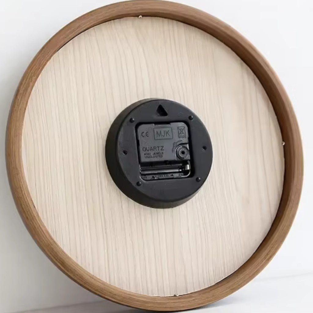 Back view of wooden wall clock showing quartz movement and wood grain