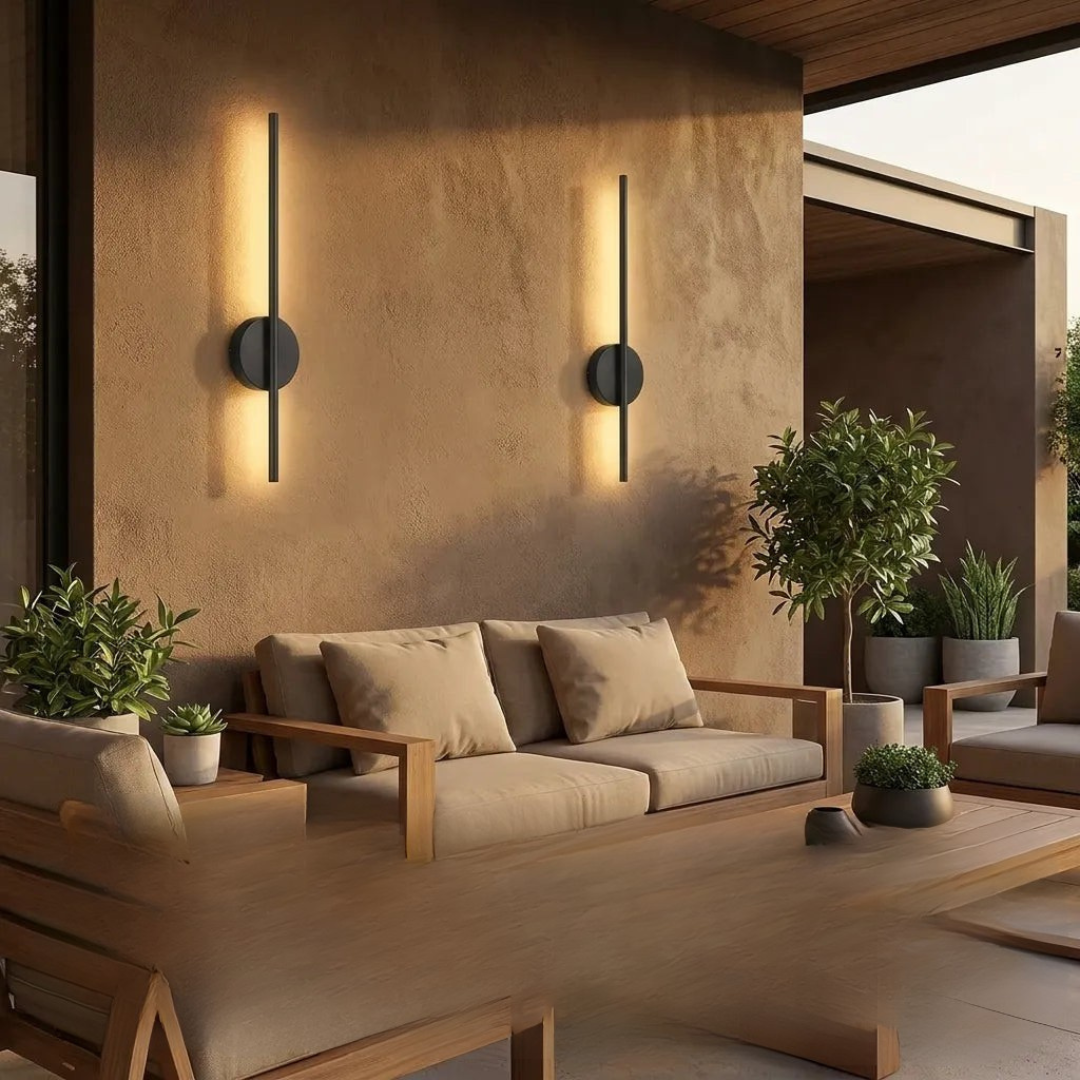 Black outdoor wall sconces on patio with plants