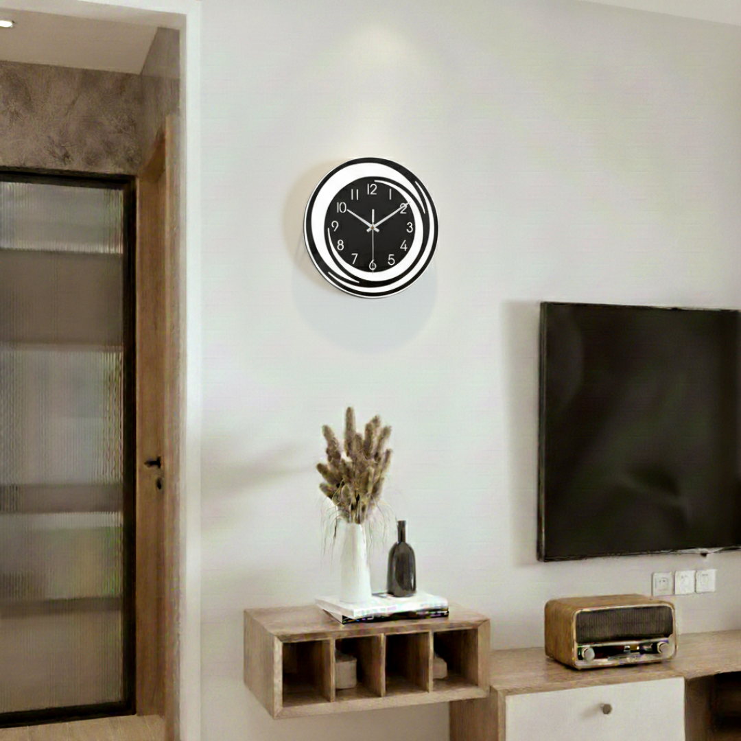 Black and white ring wall clock mounted beside TV in living room