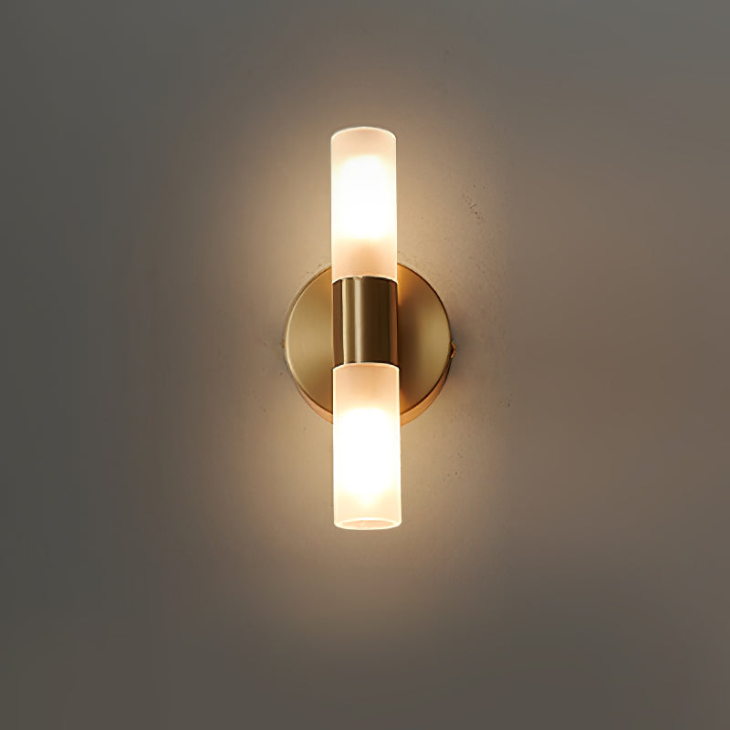 Symmetrical modern brass up-down wall fixture with dual glass cylinders