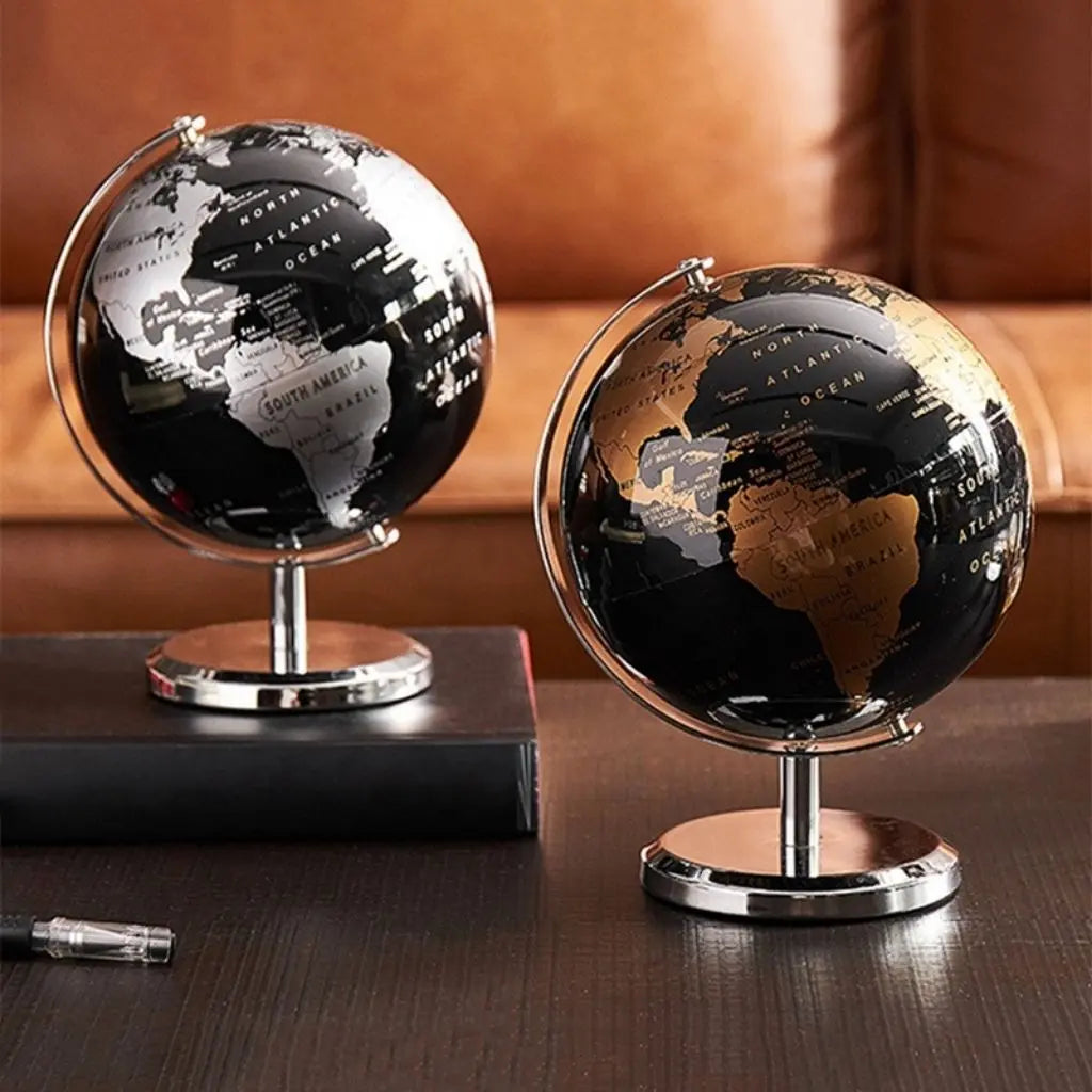 Silver and copper modern desk globes side by side