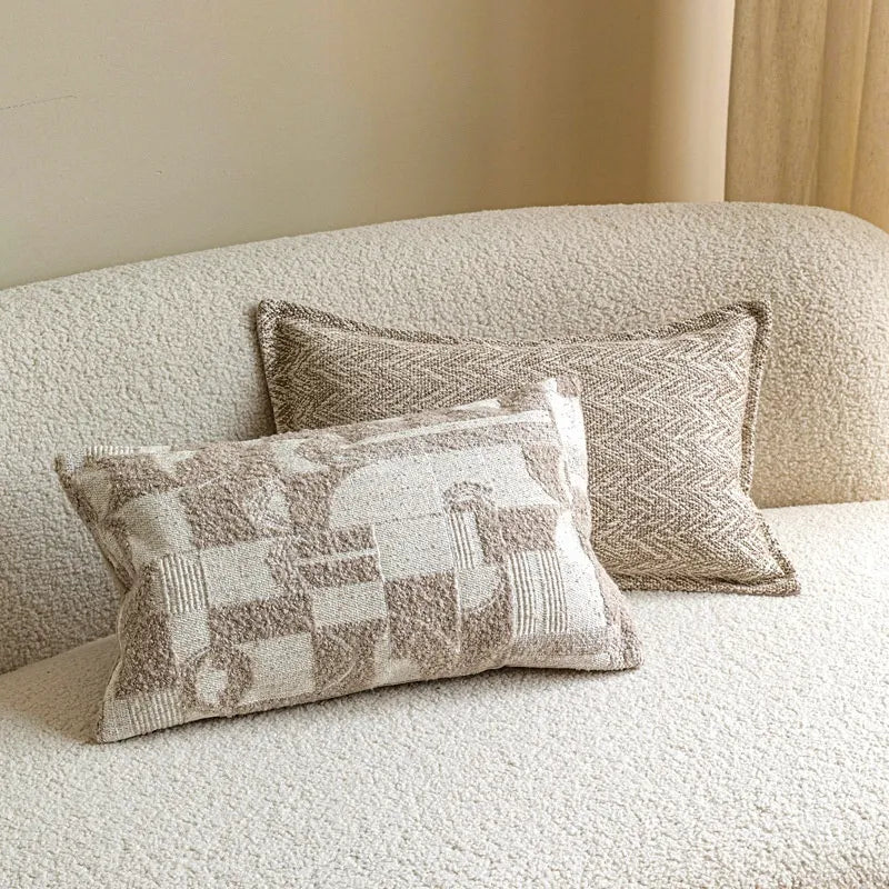 Beige geometric patchwork and brown herringbone lumbar pillows
