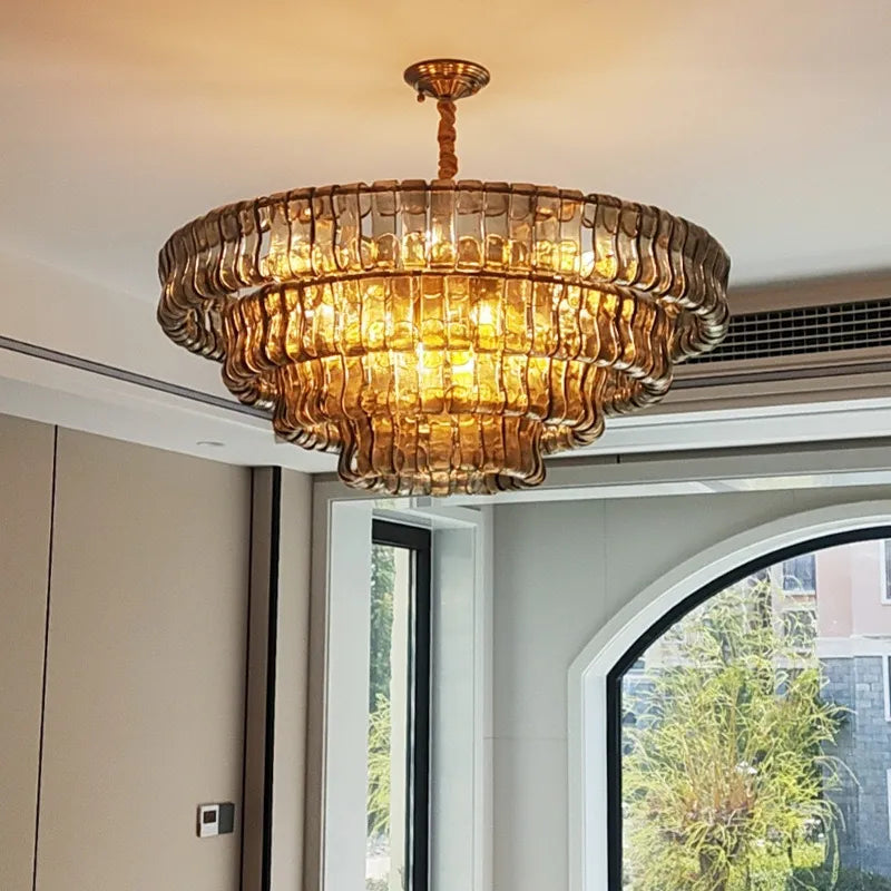 three-tier brass semi flush mount with cascading amber curved glass panels