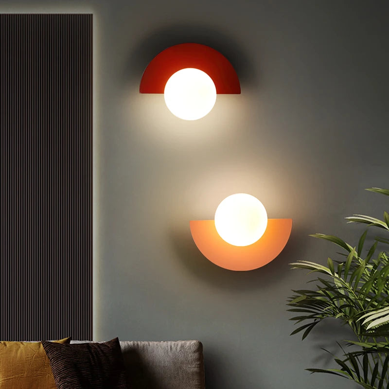 Red and orange LED wall sconces mounted vertically beside sofa in living room setting