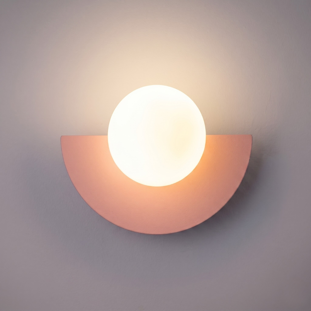 Blush pink semi-circular base LED wall light with white round plastic ball shade