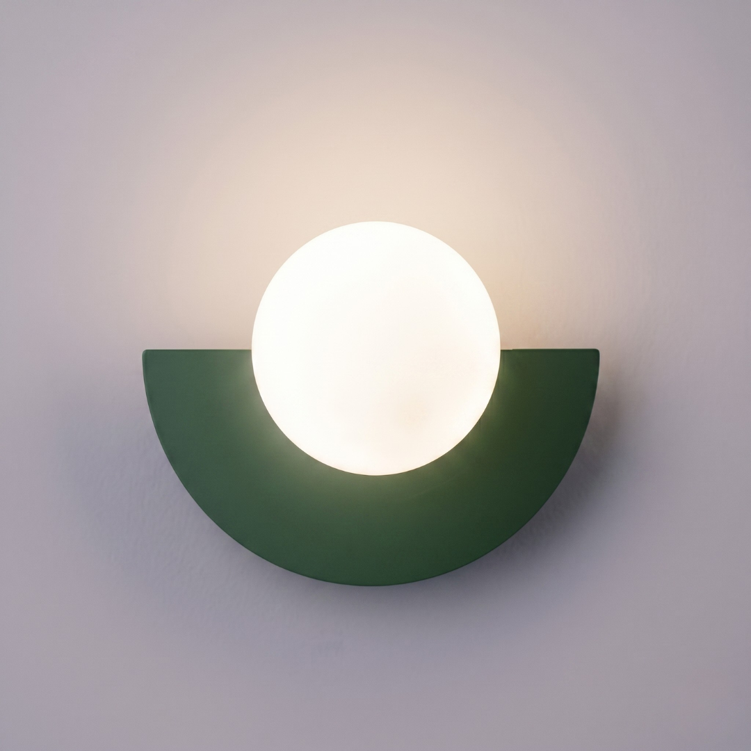 Modern LED wall sconce with dark green base and white plastic ball shade for bedroom