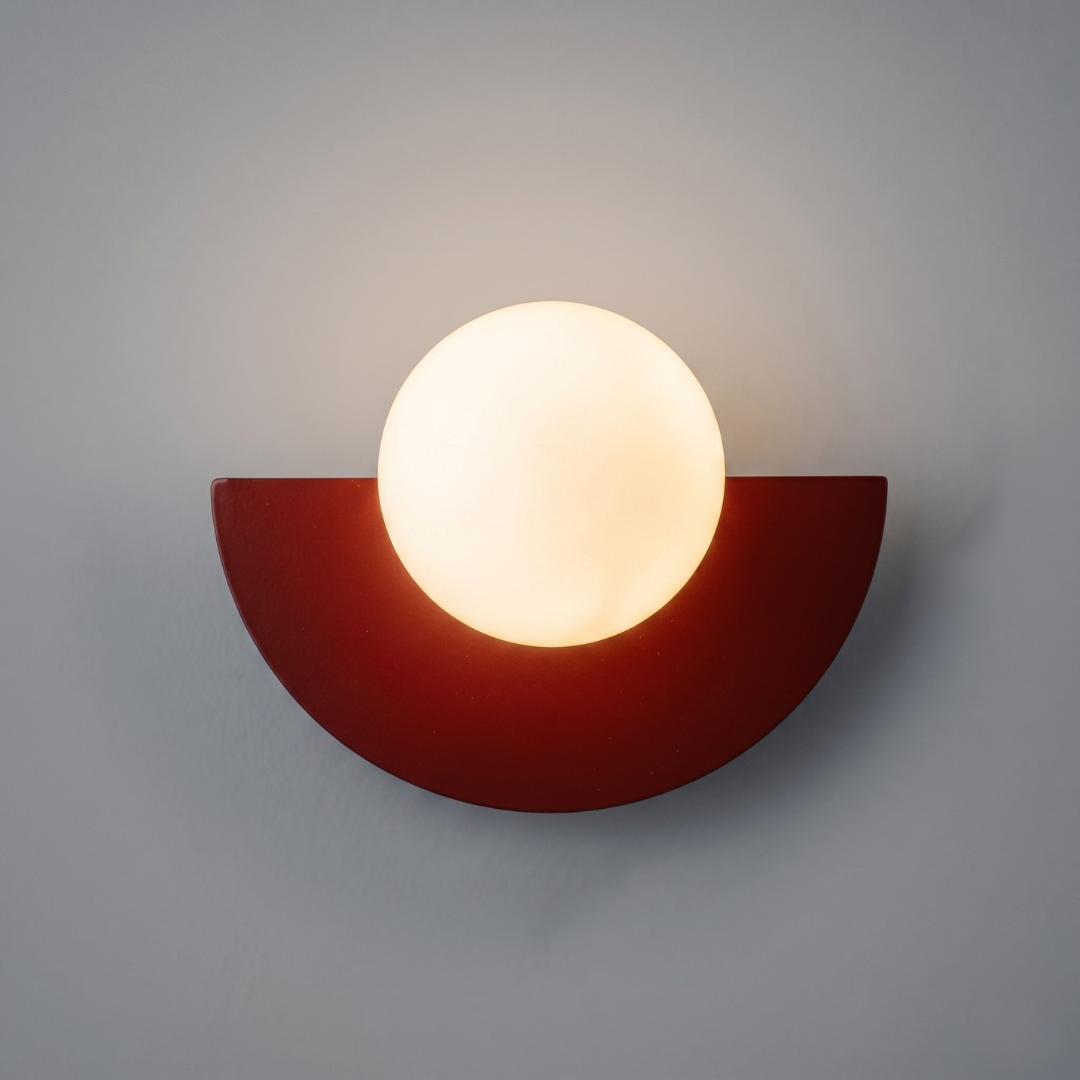 Contemporary LED wall lamp featuring deep red semi-circular base and opaque white globe shade