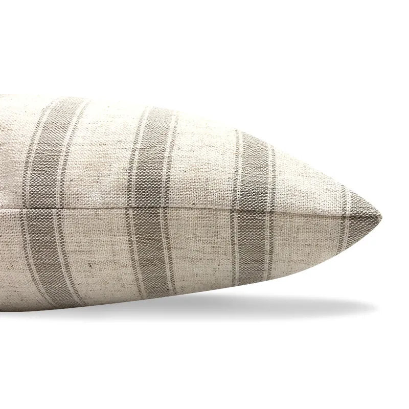 Close-up of brown striped linen pillow corner showing slub weave and stitching