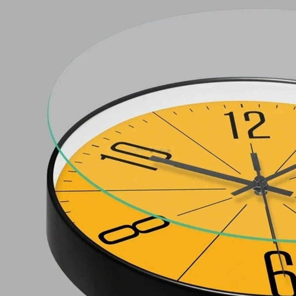 Close-up of yellow minimalist wall clock with acrylic cover and silent sweep movement