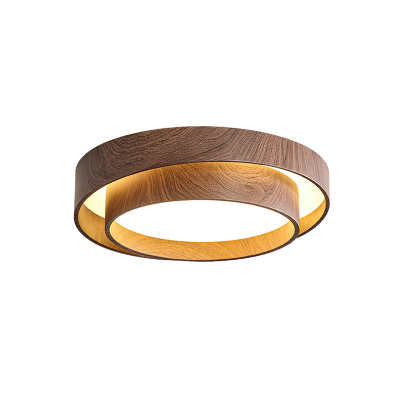 Close-up of concentric dark and light walnut wood rings on modern ceiling light