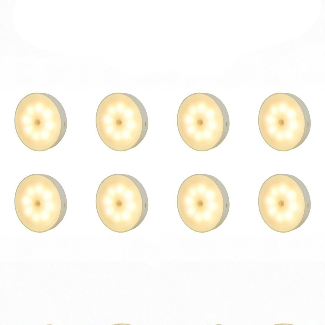 Set of eight rechargeable motion sensor puck lights with warm white LED glow