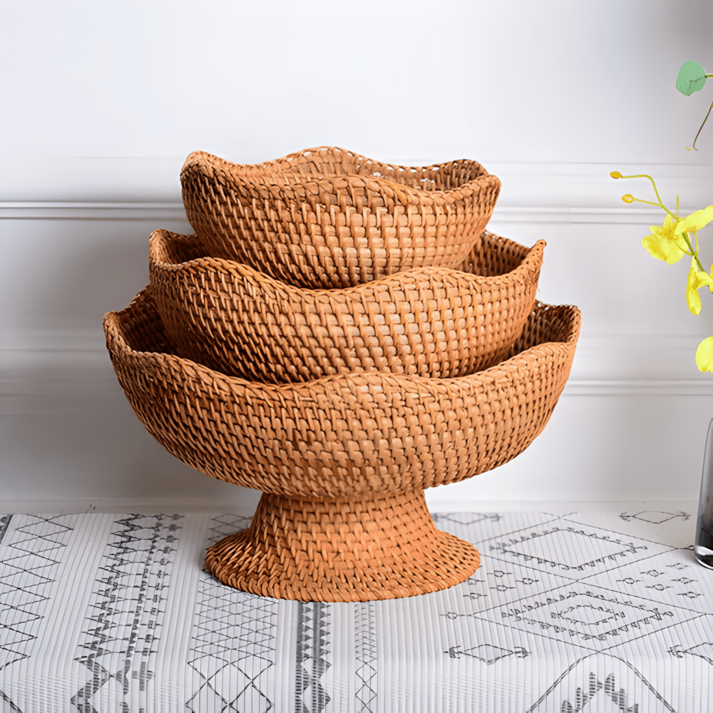 Set of three nested natural rattan fruit bowls with geometric mat background