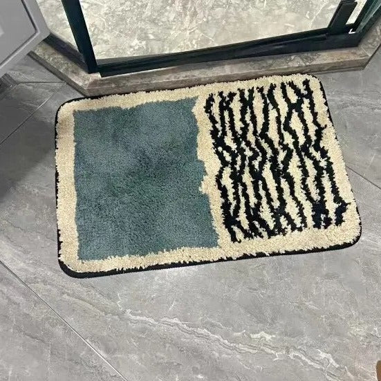 Close-up teal blue and cream abstract block plush bath mat texture detail