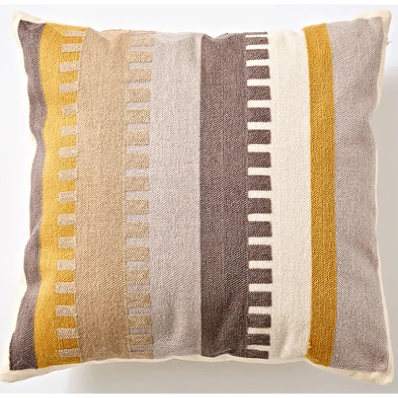 Vertical stripe cushion with embossed rectangle patterns in mustard and beige tones