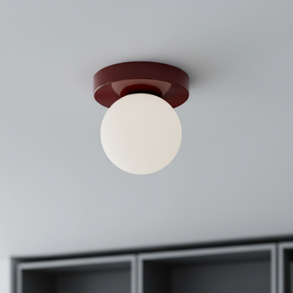 Nordic minimalist wall sconce with deep red iron base and frosted glass globe