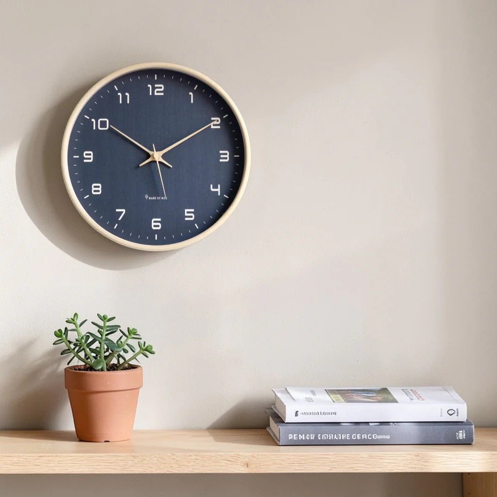 Navy blue minimalist round wood wall clock above shelf with succulent