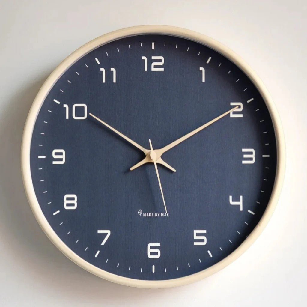 Front view of round navy blue wood frame wall clock on white wall