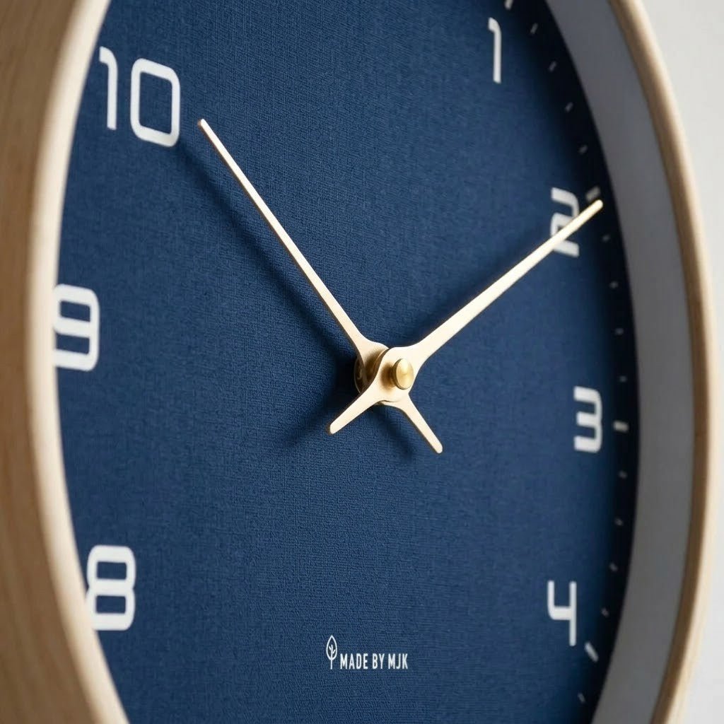 Close-up of navy blue textured face and gold hands on wood wall clock