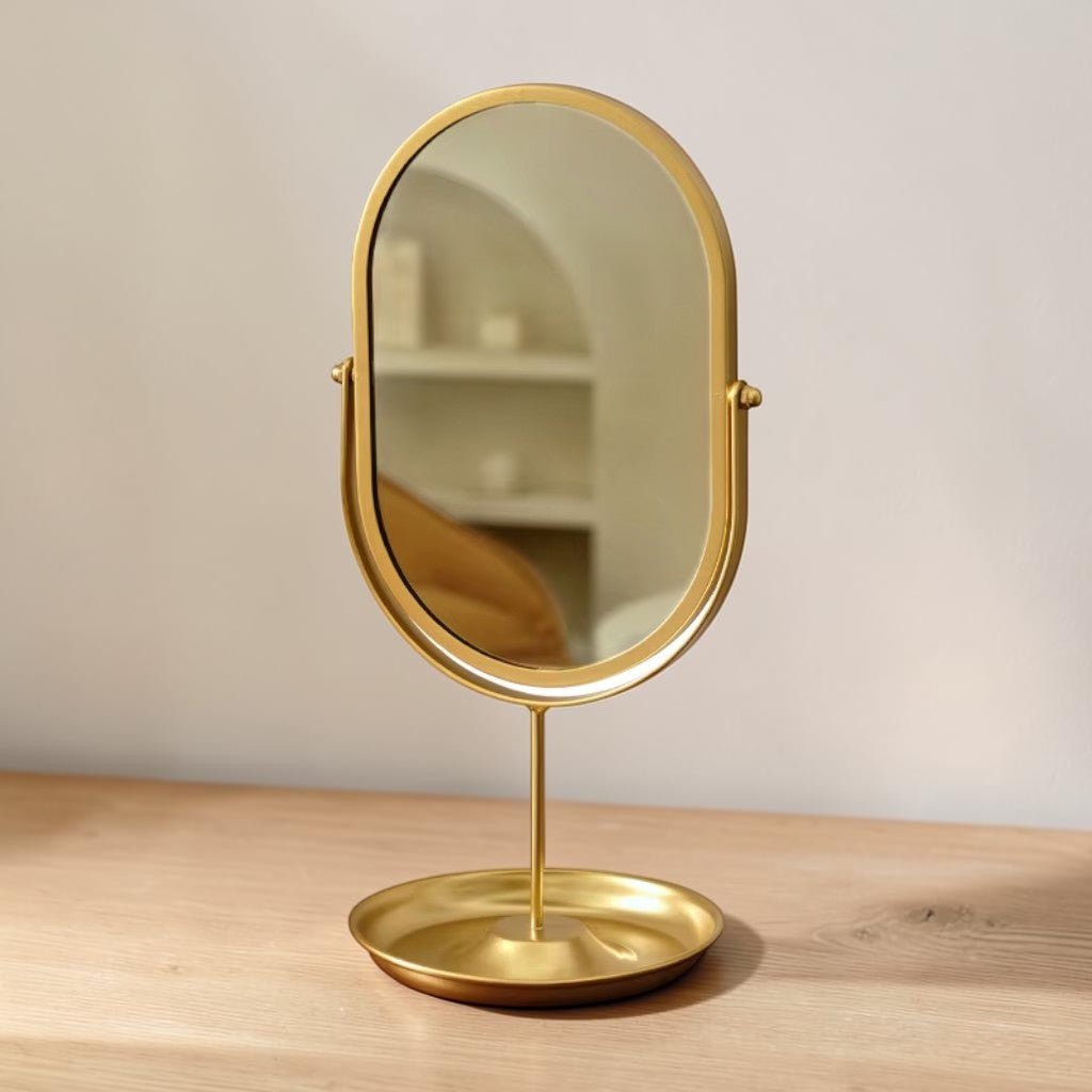 Matte gold oval vanity mirror with 360-degree rotating iron base