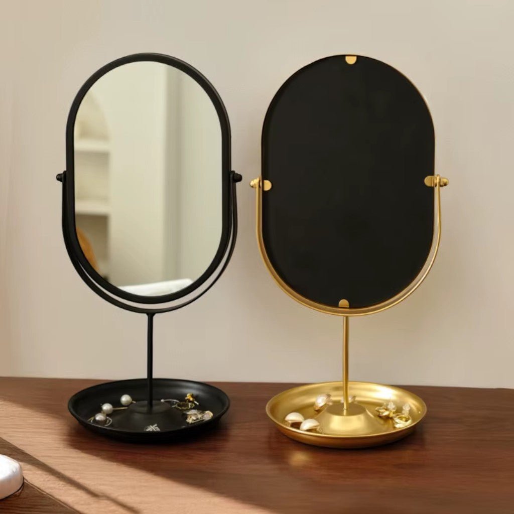 Matte gold and black oval vanity mirrors with jewelry trays side by side