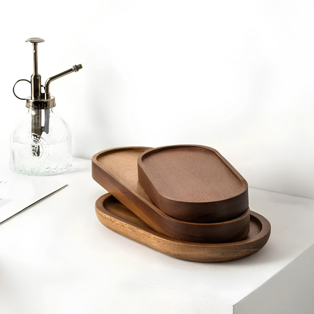 Stacked oval wooden trays showing light, medium, and dark brown wood grain finishes